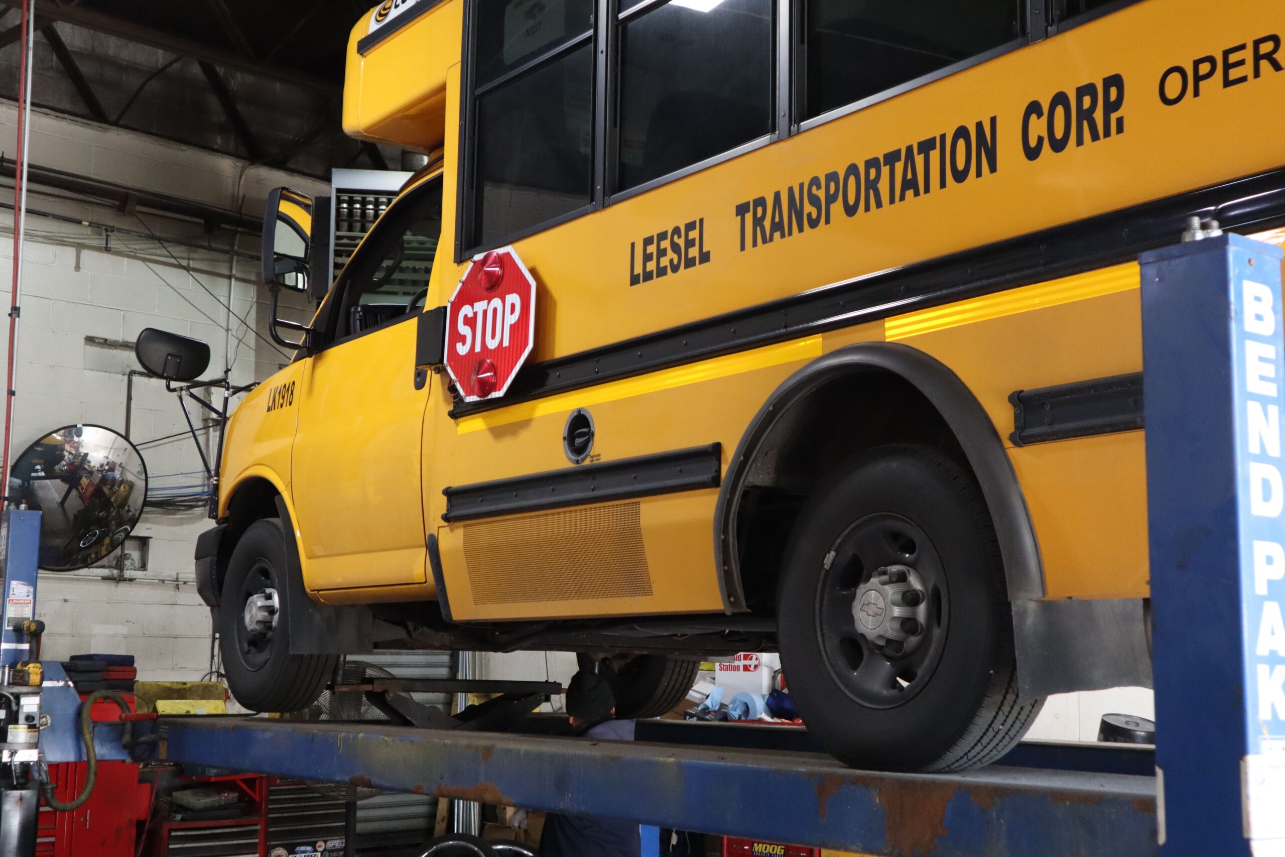 Leesel corporate shuttle parked outside Grand Central — NYC corporate transportation vehicle with company logo.