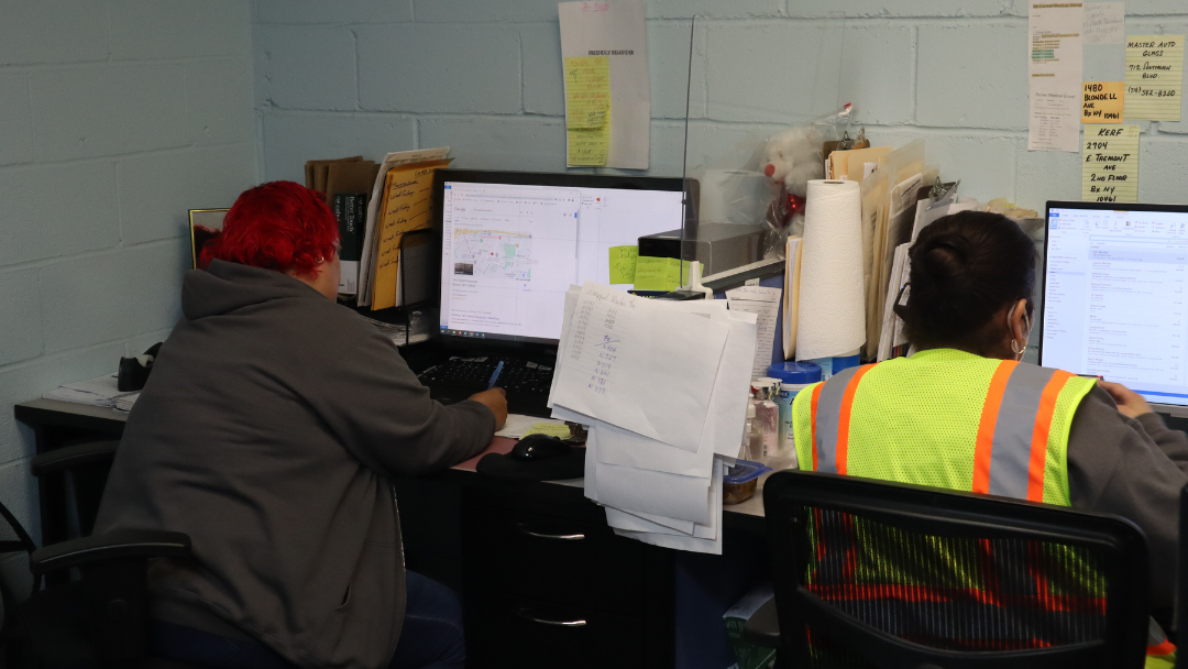 NYC winter transportation needs for schools with yellow school bus on snowy city street